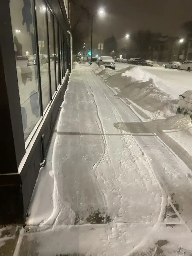 Storefront sidewalk, cleared at night